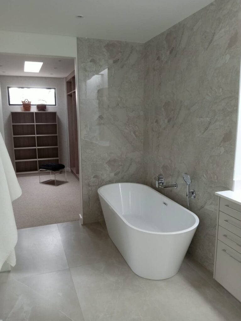 Freestanding bath and stone-look tiles